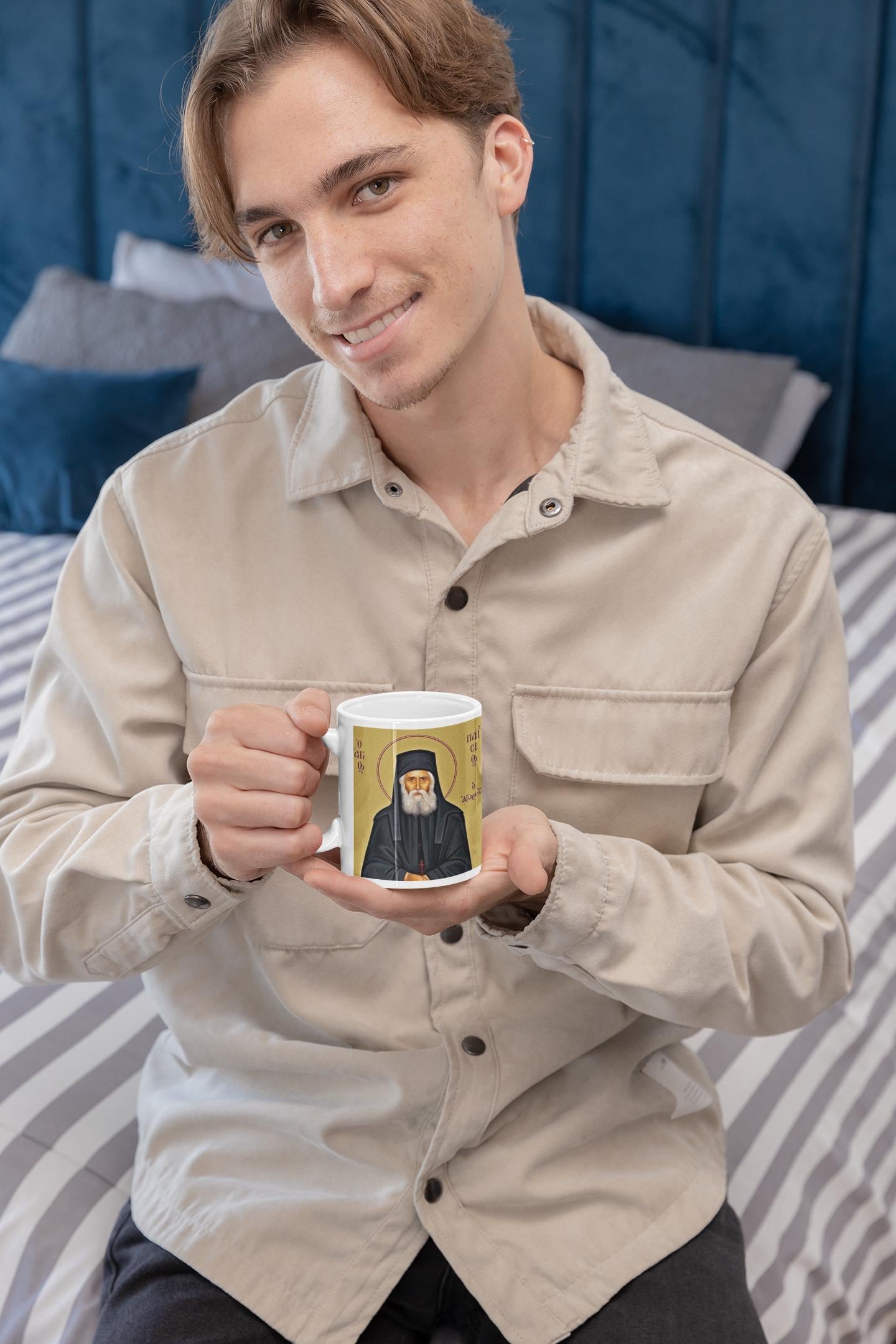 Celebrate Saint Paisios of Mount Athos with this Orthodox Christian Mug, featuring his inspiring quote: "The goal of the Christian is to resemble Christ." Durable ceramic, microwave & dishwasher safe—perfect for daily use, prayer, or as a faith gift.