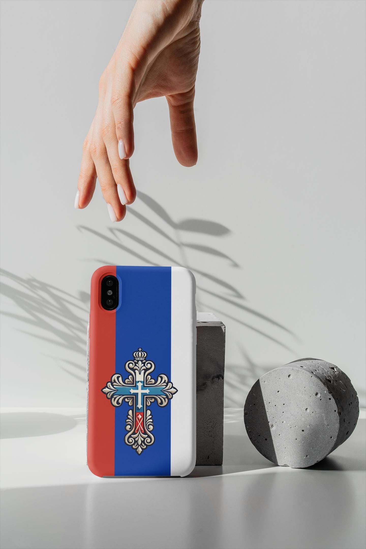 Showcase your Russian Orthodox faith with this premium phone case featuring a Russian Orthodox Cross in white, blue, and red. Made with polycarbonate & TPU, it’s durable, shock-absorbent, and wireless charging compatible.