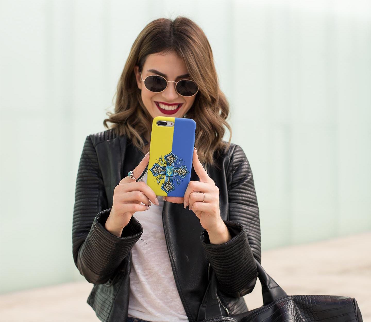 Showcase your Ukrainian Orthodox faith with this premium phone case featuring a Ukrainian Orthodox Cross in blue and yellow. Made with polycarbonate & TPU, it’s durable, shock-absorbent, and wireless charging compatible